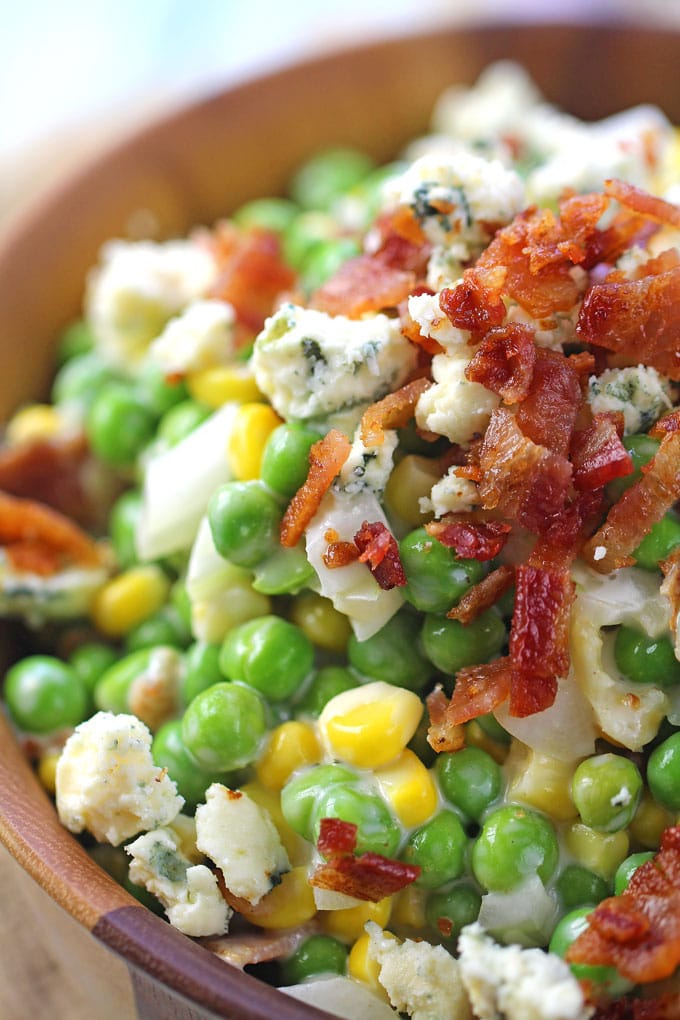 Creamy Ranch Bacon Pea Salad with sweet corn, is the perfect summery side dish. Made with creamy ranch, lots of blue cheese and delicious, crispy bacon.