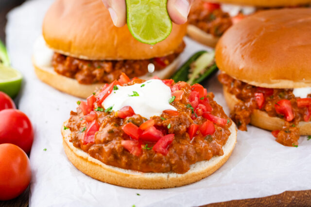 Homemade taco sloppy Joes with ground meat, salsa, and sour cream.