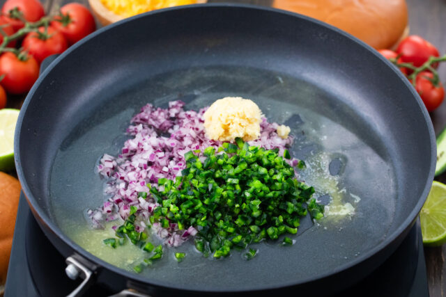 Saut&eacute;ing red onion, garlic, and parsley.