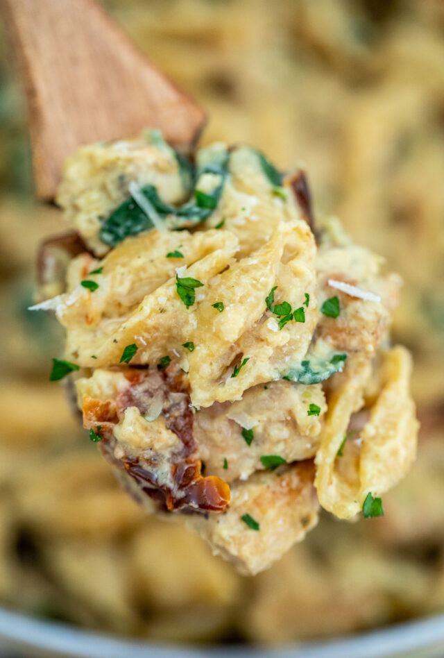 Tuscan Chicken Pasta is a quick and easy one-pan dish made with crispy chicken, sun-dried tomatoes, shell pasta, and soaked in a creamy white sauce. #pasta #tuscanchicken #chickenrecipes #30minutemeals #onepotmeals