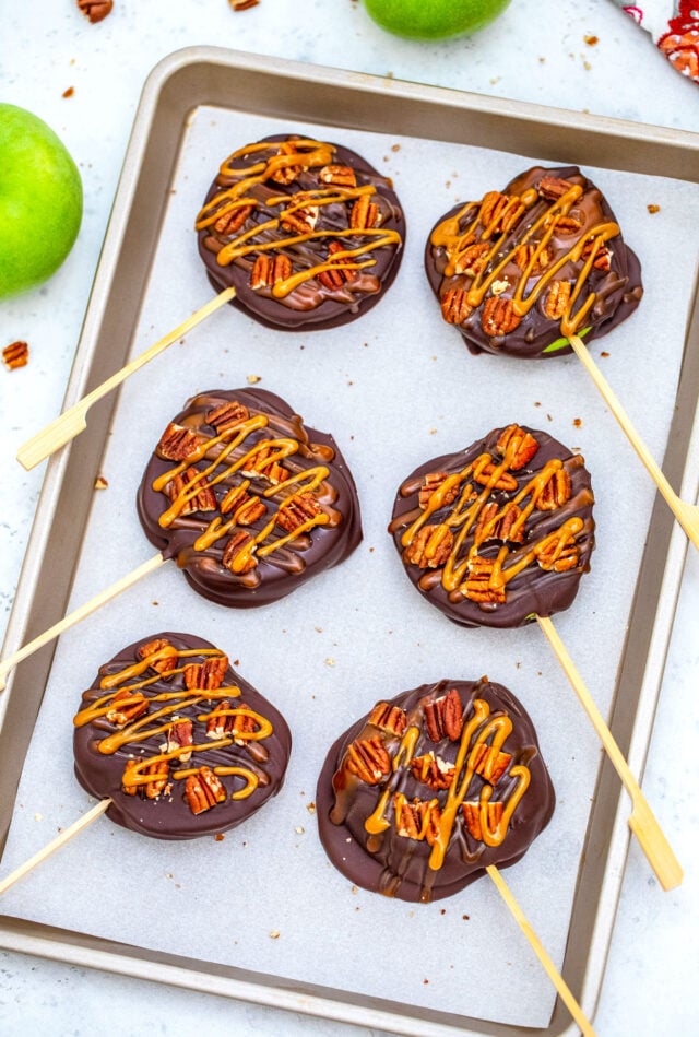 Chocolate Turtle Apples are made with sliced fresh apples, dipped in melted chocolate, drizzled with caramel sauce and topped with pecans. #fallrecipes #apples #caramel #30minutesmeals #halloween