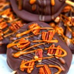 Chocolate Turtle Apples are made with sliced fresh apples, dipped in melted chocolate, drizzled with caramel sauce and topped with pecans. #fallrecipes #apples #caramel #30minutesmeals #halloween