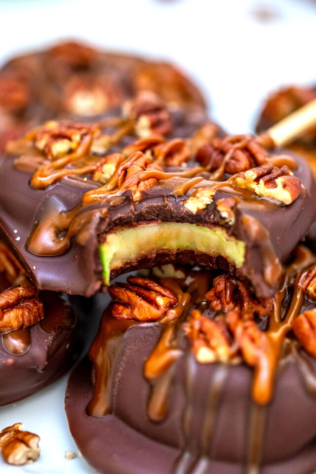 Chocolate Turtle Apples are made with sliced fresh apples, dipped in melted chocolate, drizzled with caramel sauce and topped with pecans. #fallrecipes #apples #caramel #30minutesmeals #halloween
