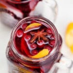 Orange Cranberry Sangria bursts with flavors reminiscent of autumn and winter! This makes for the perfect cocktail for upcoming holidays, with hints of orange and spices! #sangria #cranberrysangria #30minutemeals #fallrecipes #thanksgiving #christmas