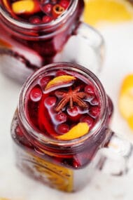 Orange Cranberry Sangria bursts with flavors reminiscent of autumn and winter! This makes for the perfect cocktail for upcoming holidays, with hints of orange and spices! #sangria #cranberrysangria #30minutemeals #fallrecipes #thanksgiving #christmas