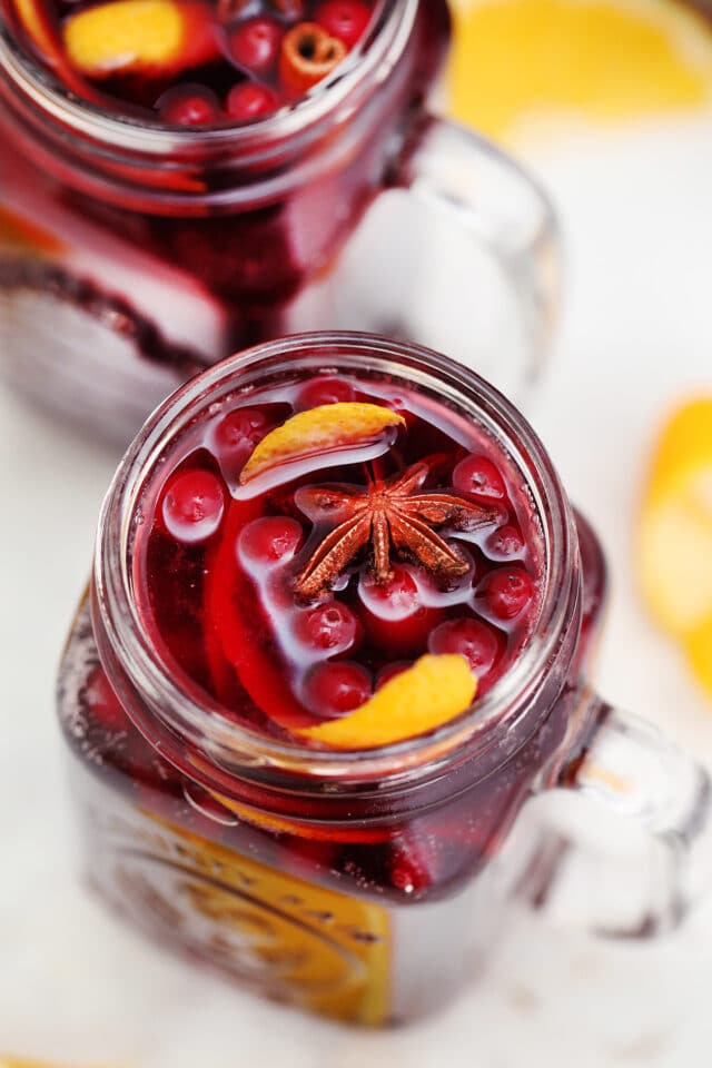 Orange Cranberry Sangria bursts with flavors reminiscent of autumn and winter! This makes for the perfect cocktail for upcoming holidays, with hints of orange and spices! #sangria #cranberrysangria #30minutemeals #fallrecipes #thanksgiving #christmas