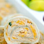 These Taco Tortilla Roll Ups are made with shredded chicken, cream cheese, taco seasoning, and cheddar cheese. #rollups #pinwheels #taco #partyfood #30minutemeals