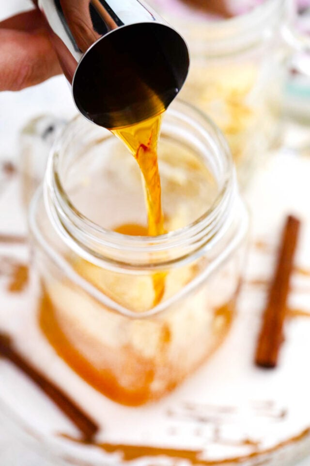 Assembling spiced buttered rum drink.