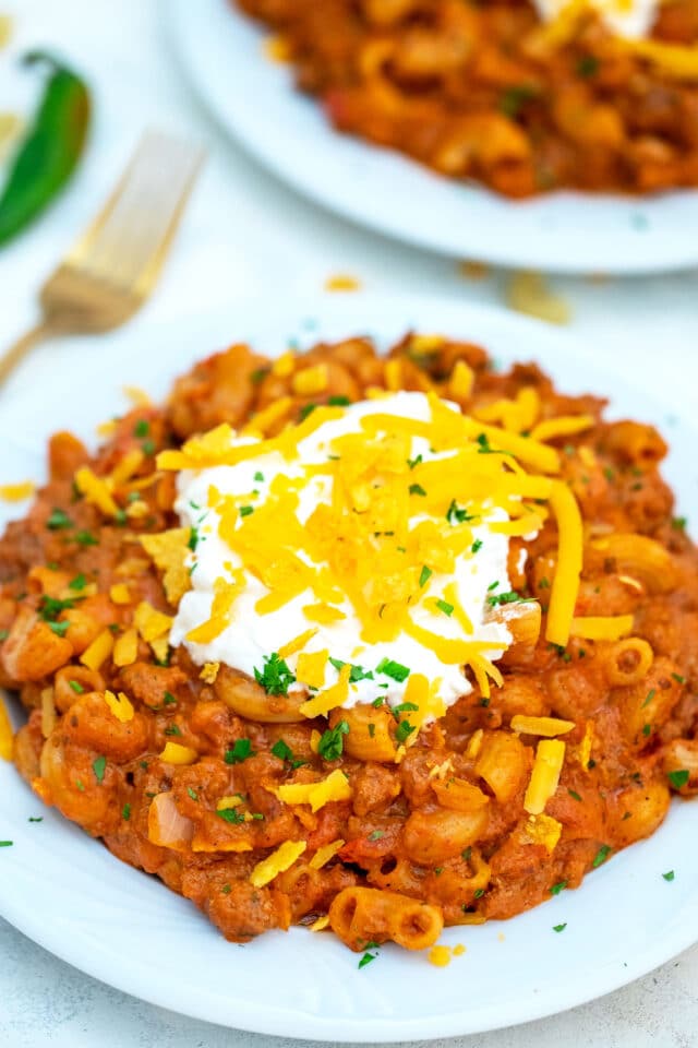 One Pan Taco Mac and Cheese is made with ground beef, taco seasoning, macaroni, and cheddar cheeses. #pasta #macandcheese #tacopasta #30minutemeals #onepan