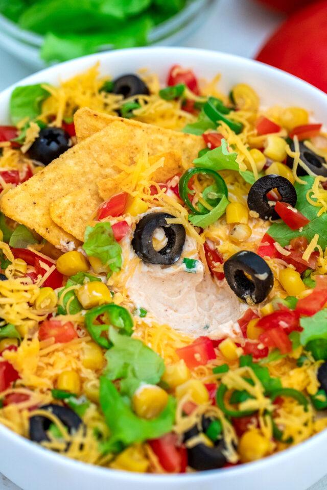 Taco Dip is the perfect snack for game day or party appetizer that is ready in just 5 minutes. #tacodip #appetizers #partyfood #30minutemeals #mexicanrecipes