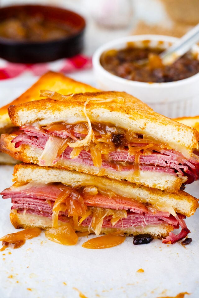 French dip grilled cheese sandwich with golden bread, caramelized onions, and melted provolone, served with au jus.