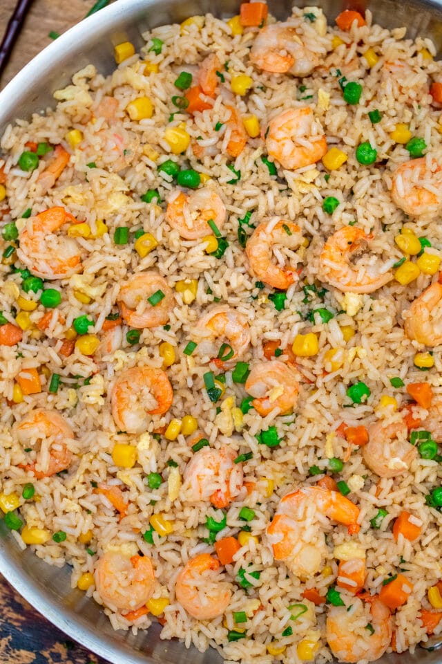 Shrimp Fried Rice recipe is made with fresh shrimp, rice, green onions, peas, carrots, and sesame oil. It is a classic dinner dish that is ready in about 30 minutes! #friedrice #shrimprecipes #30minutemeals #shrimpfriedrice #chineserecipes