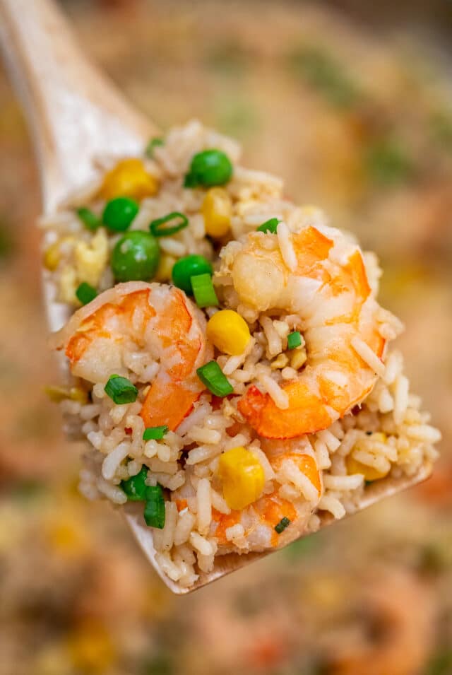 Shrimp Fried Rice recipe is made with fresh shrimp, rice, green onions, peas, carrots, and sesame oil. It is a classic dinner dish that is ready in about 30 minutes! #friedrice #shrimprecipes #30minutemeals #shrimpfriedrice #chineserecipes