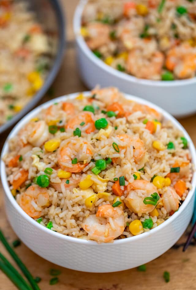 Shrimp Fried Rice recipe is made with fresh shrimp, rice, green onions, peas, carrots, and sesame oil. It is a classic dinner dish that is ready in about 30 minutes! #friedrice #shrimprecipes #30minutemeals #shrimpfriedrice #chineserecipes