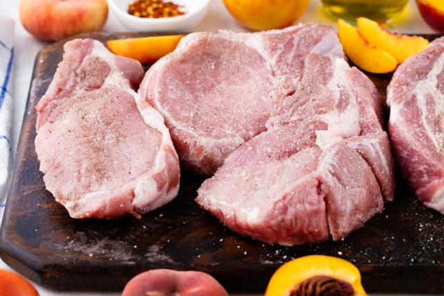 Seasoning pork chops.