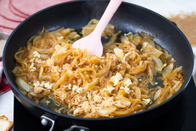 Sweet onions and brown sugar caramelizing in a cast iron skillet for the au jus sauce.