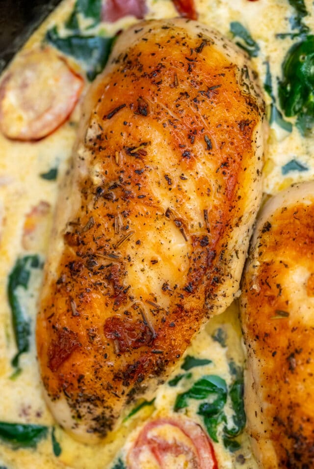 Creamy Tuscan Chicken is a one-pan recipe made with juicy seared chicken breasts soaked in the most delicious creamy sauce. #chickenrecipes #tuscanchicken #onepan #30minutemeals #chickenfoodrecipes