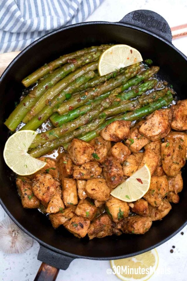 chicken with asparagus in a cast iron pan