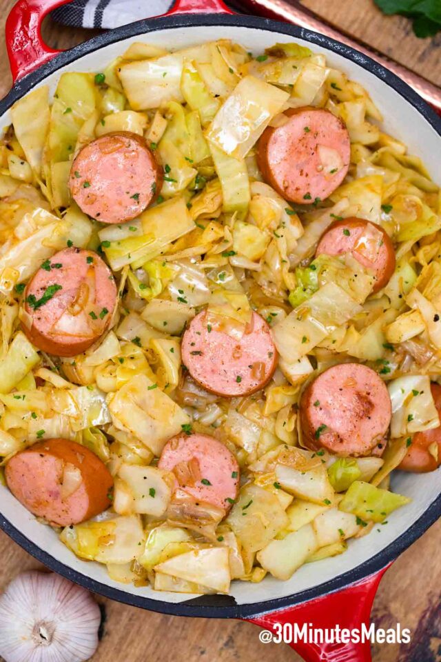 fried cabbage and kielbasa in a pan