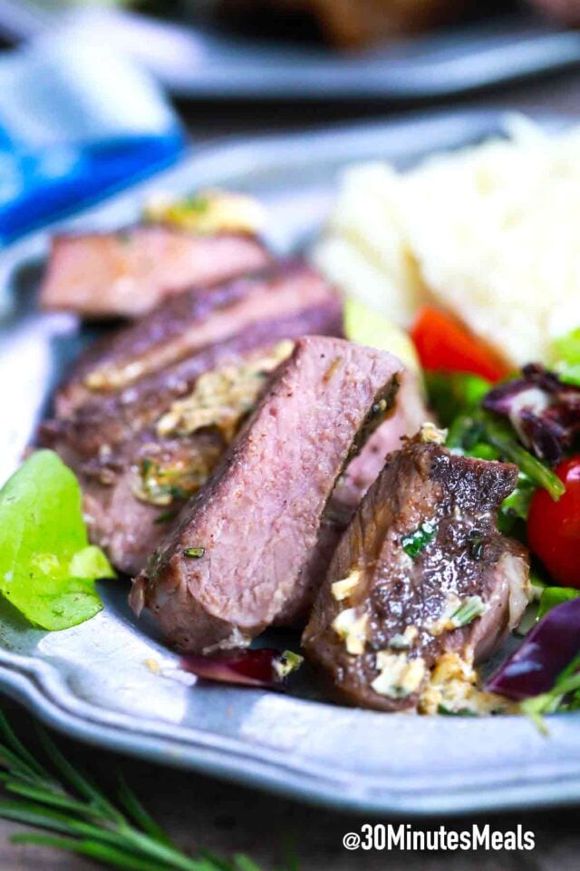 sliced steak with mashed potatoes