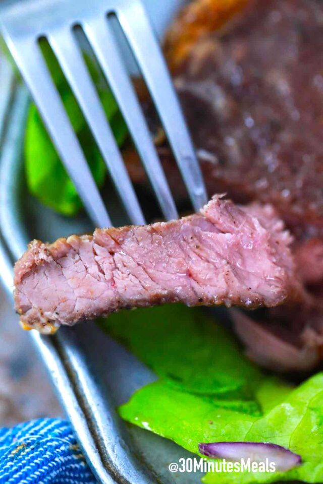 a piece of steak on a fork