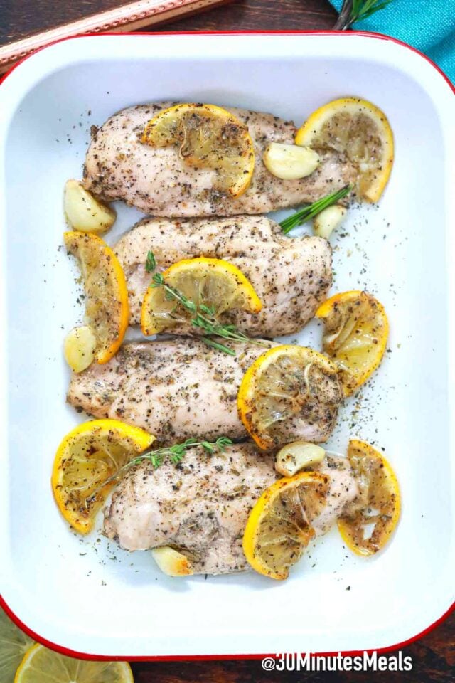 baked garlic lemon chicken breasts in a baking dish