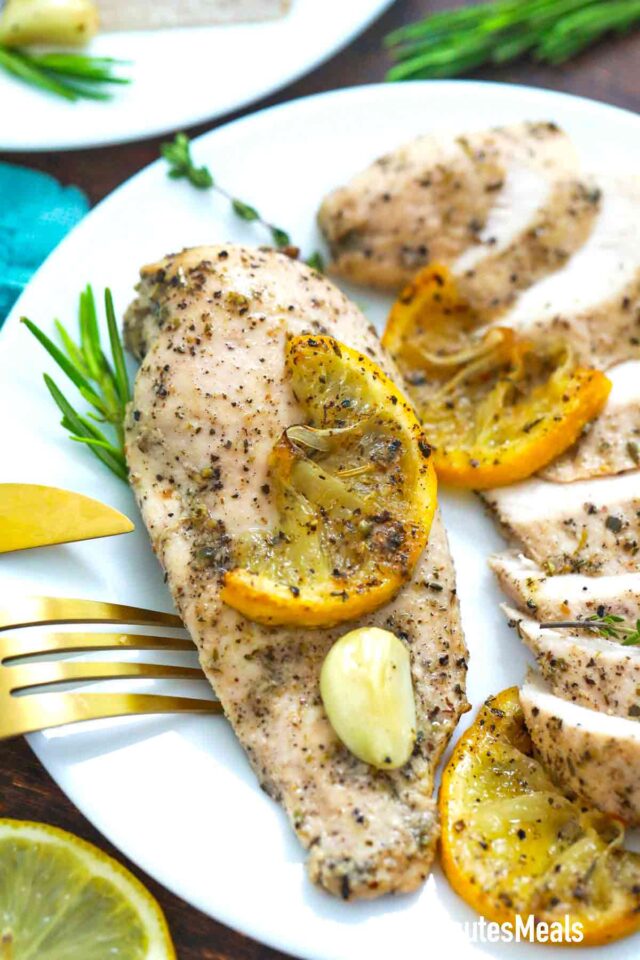 baked garlic lemon chicken breasts on a plate