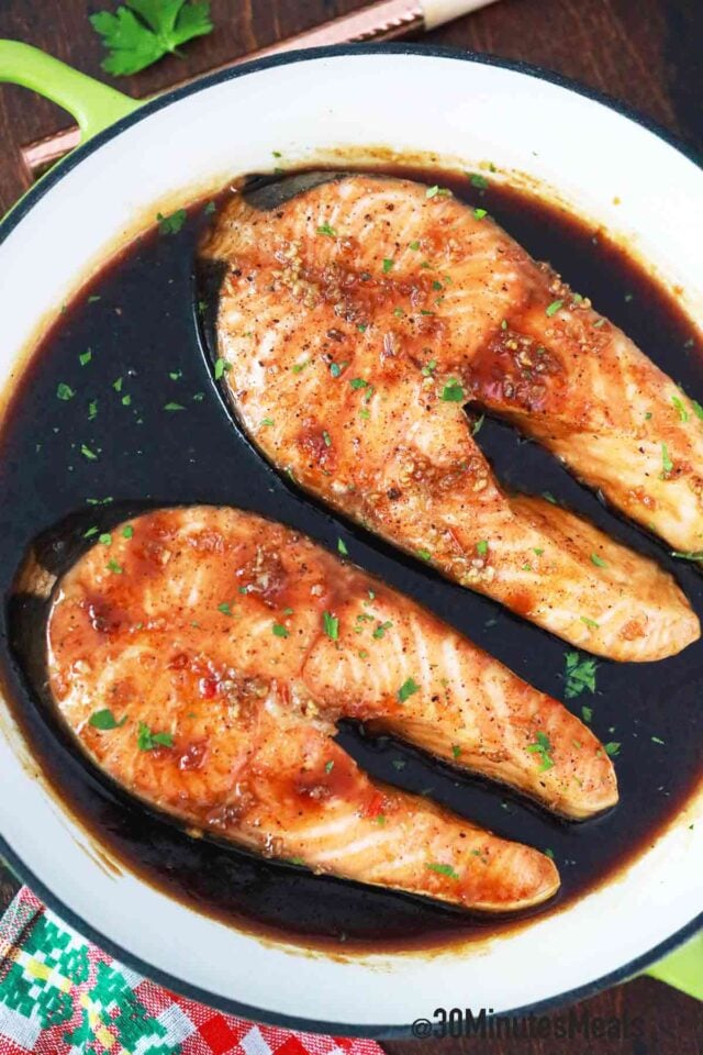 salmon steaks in sauce in a pan