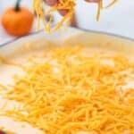adding cheddar cheese to pumpkin pasta sauce