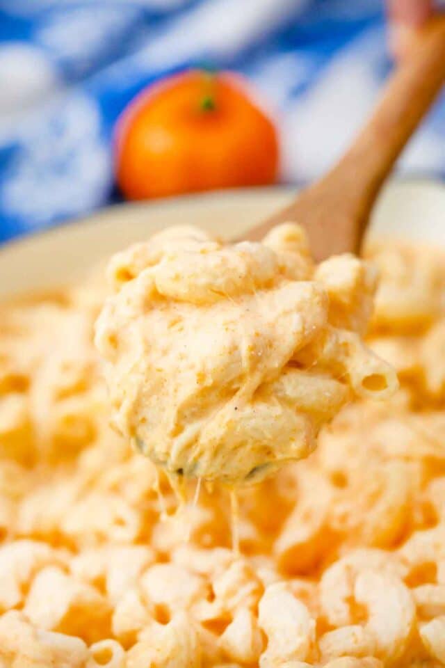 pumpkin mac and cheese on a wooden spoon