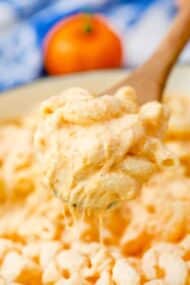 pumpkin mac and cheese on a wooden spoon