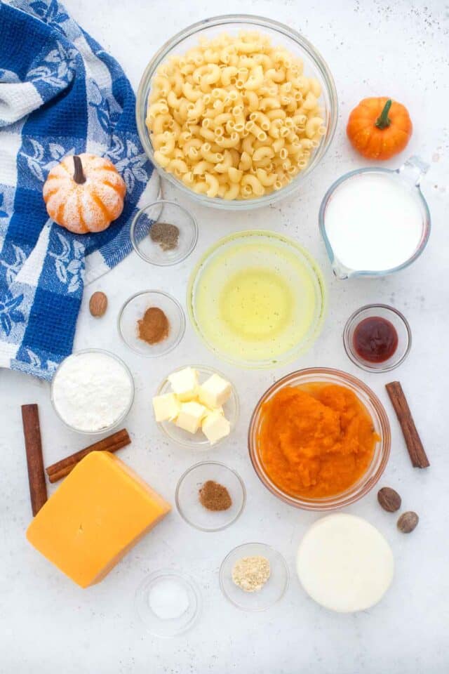 overhead shot of pumpkin mac and cheese ingredients in bowls on a table