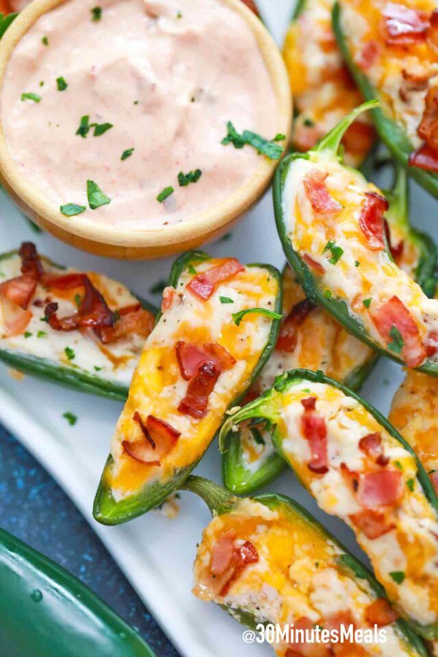 jalapeno poppers on a plate with sauceee