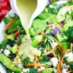 pouring avocado dressing on salad