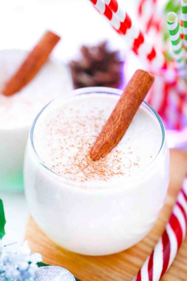 a glass of homemade eggnog with a cinnamon stick