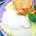 gravy on top of mashed potatoes with chicken and veggies