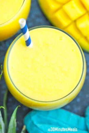 overhead shot of a glass with mango pineapple smoothie