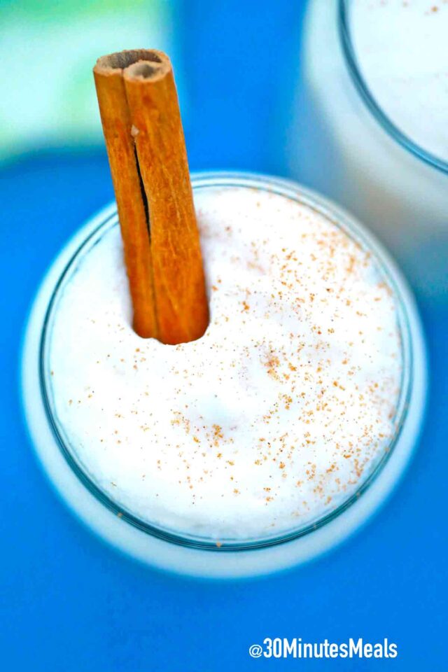 mexican horchata sprinkled with cinnamon and topped with a cinnamon stick