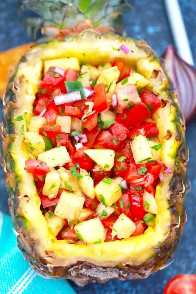 a fresh pineapple boat filled with Pineapple Mango Salsa