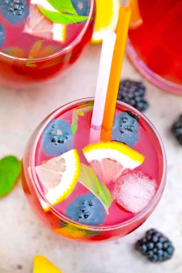 overhead shot of blackberry lemonade with blackberries and lemon