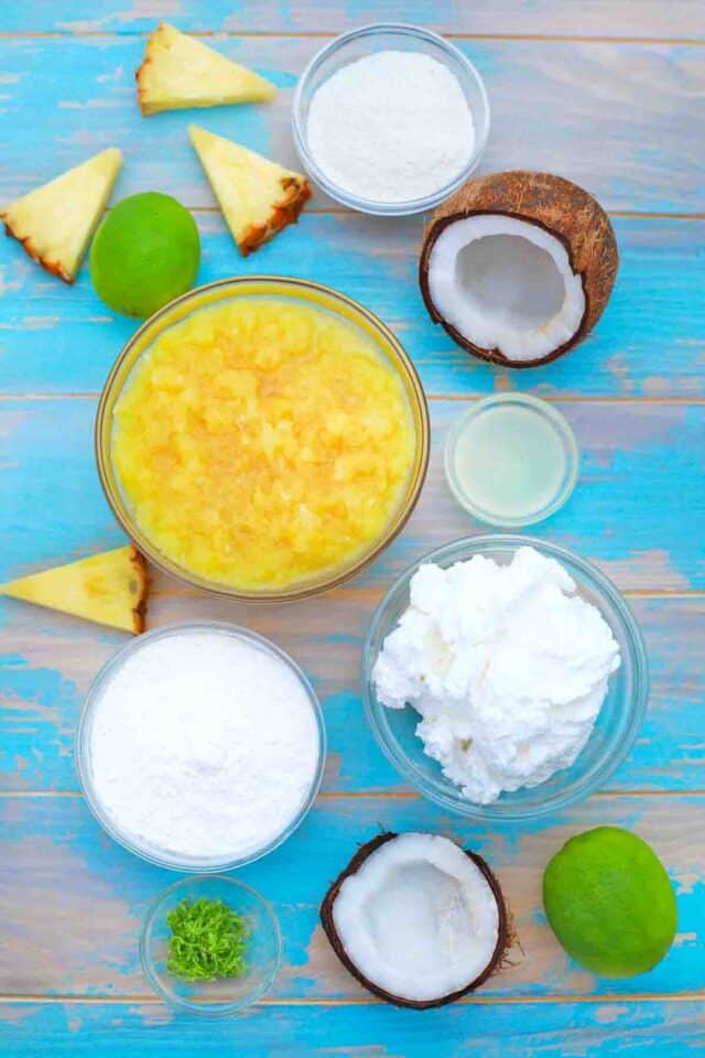 overhead shot of pineapple coconut whipped topping lime on a blue surface