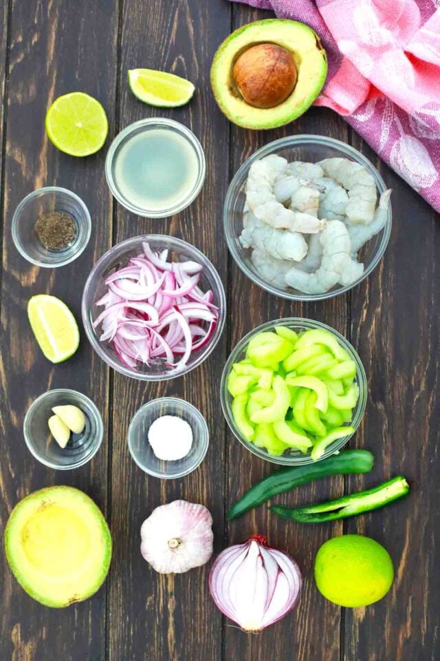 overhead shot of shrimp lime avocado onion in bowls