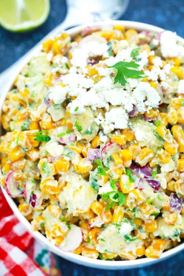 overhead shot of a bowl of creamy corn salad with cotija cheese