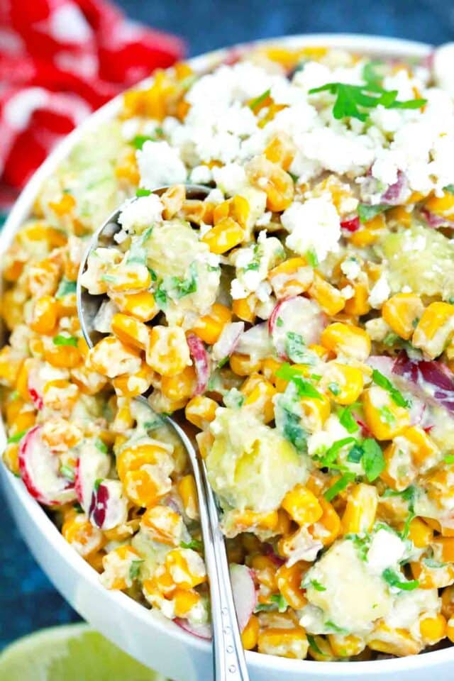 a bowl of avocado corn salad with Cotija cheese