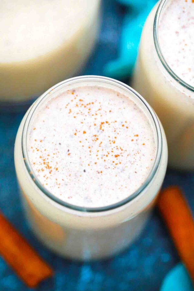 overhead shot of puerto rican coquito with a sprinkle of cinnamon
