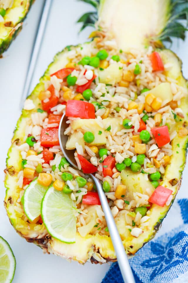 overhead shot of thai pineapple fried rice served with lime slices