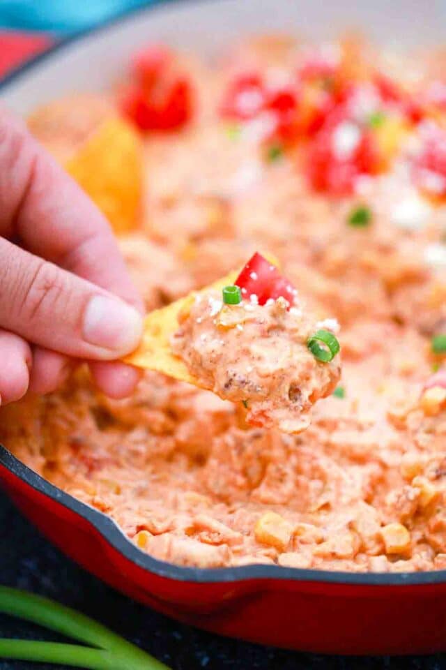 dipping corn chips in velveeta sausage dip