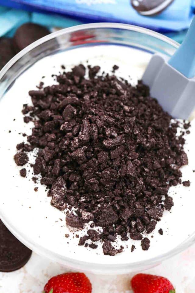 stirring oreo crumbs into whipped cream