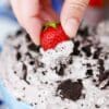 dipping a strawberry in oreo dip