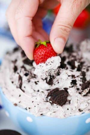 dipping a strawberry in oreo dip